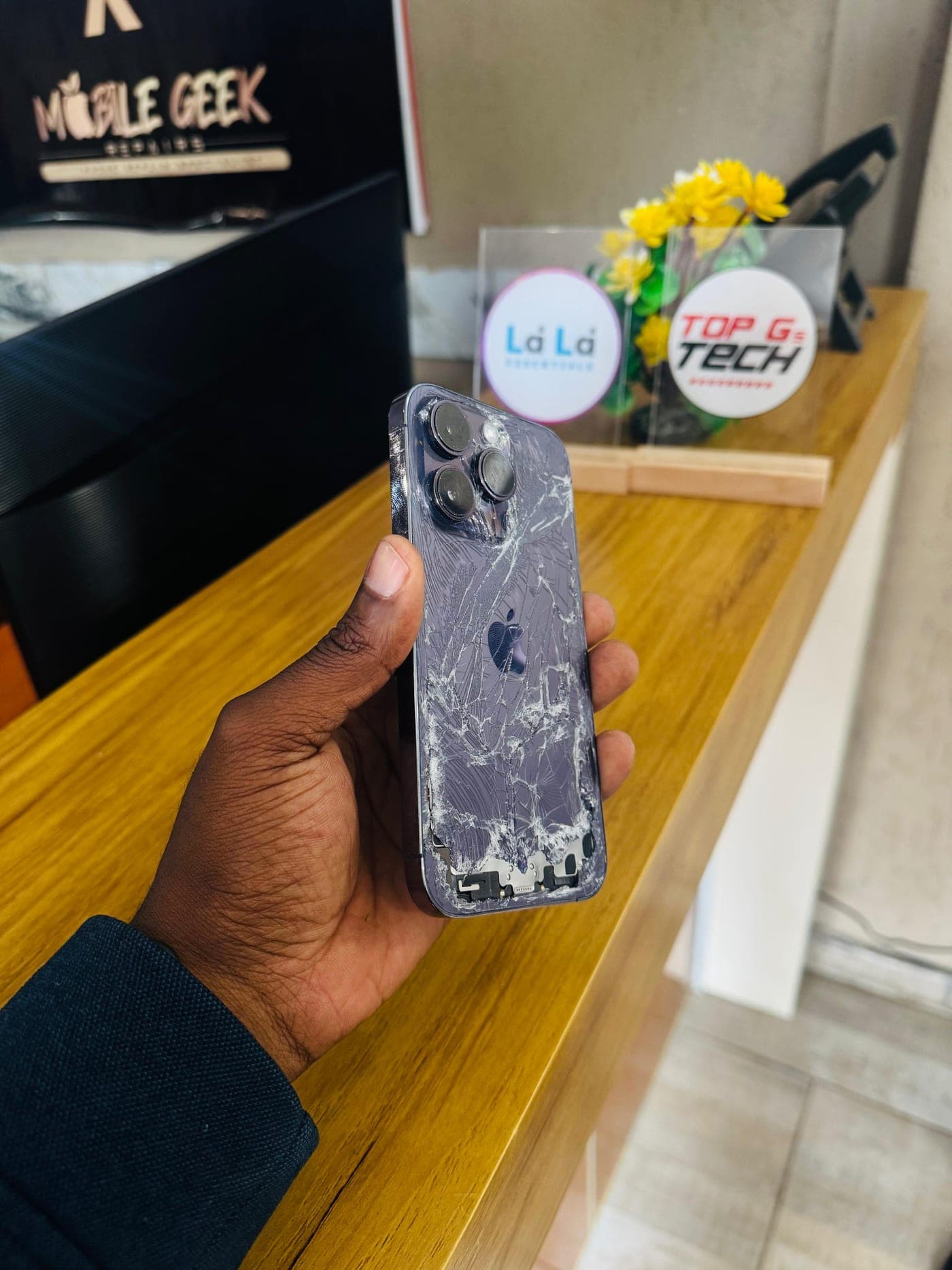 iPhone Back Glass Replacement - the device before repair, showing the damage