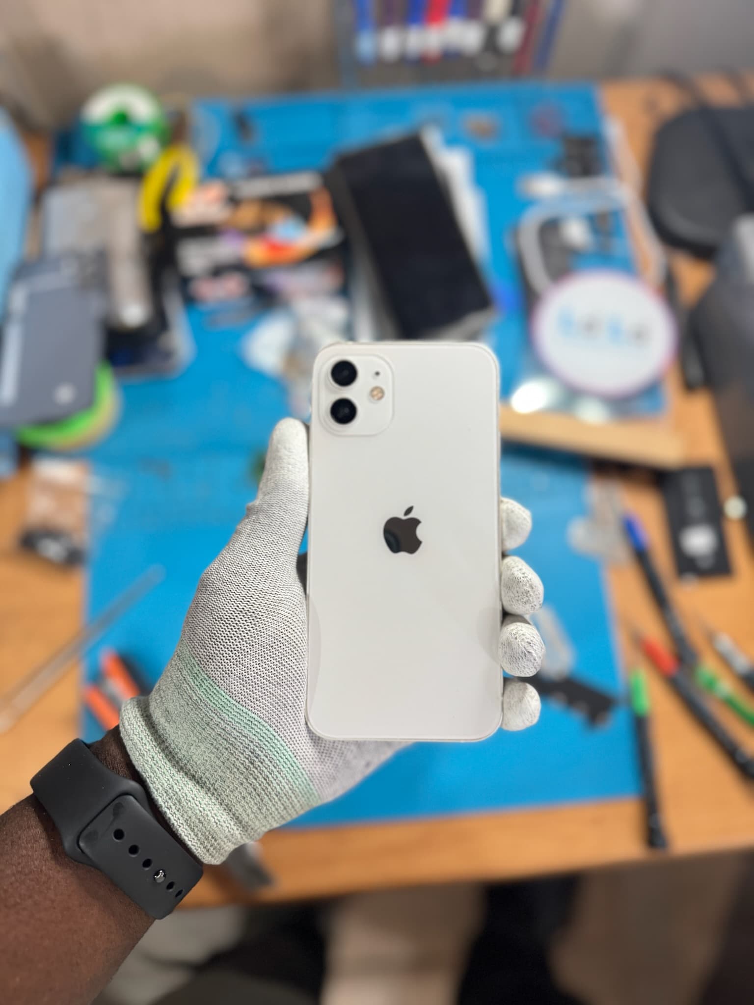 A repaired iPhone being checked at the Top Gs Tech workbench