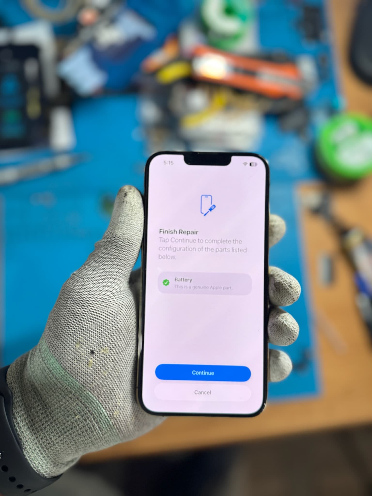 Genuine part verification during an iPhone repair at Top Gs Tech